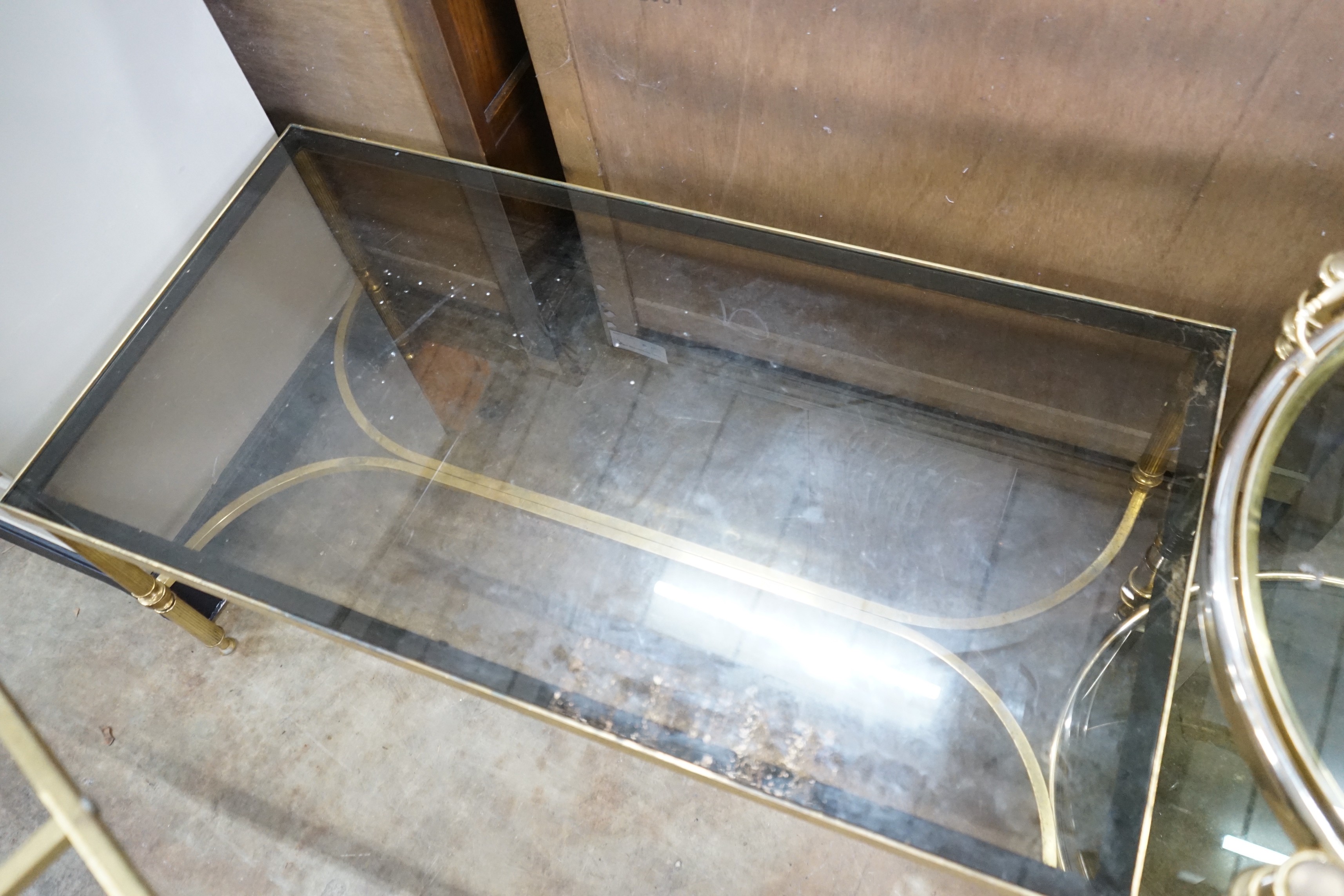 A brass and smoked glass rectangular coffee table, width 99cm, depth 51cm, height 42cm